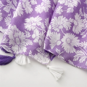 Detail showing purple floral pattern fabric and bicolored handmade tassel fringe edges