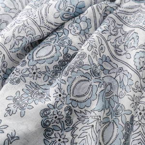 Detail of blue paisley floral patterns on soft linen-textured cotton scarf fabric