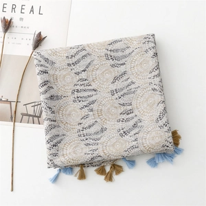 Detail of bohemian geometric ring pattern on linen-feel scarf with stylish tassels