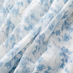 Close-up of lightweight light blue floral print scarf with soft linen texture