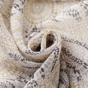 Macro shot of cotton linen scarf showing bohemian mandala patterns and soft tassels