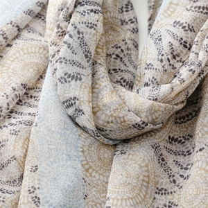 Macro detail of mandala pattern print and tassel fringe on cotton linen scarf