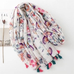 Detail of vintage floral print scarf with colorful flower patterns and fringe tassels