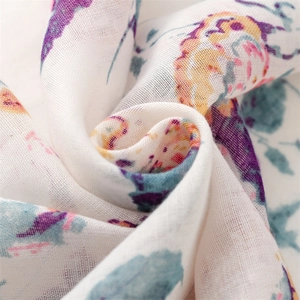Close-up of lightweight cotton linen scarf showing colorful floral paisley pattern and texture