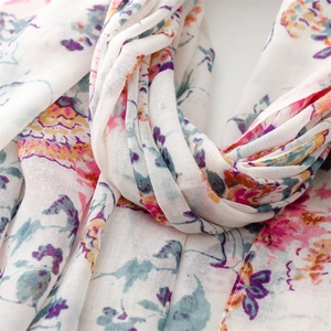Close-up of lightweight floral scarf showing fine cotton linen texture and fringes