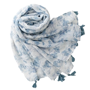 Lightweight cotton linen scarf with blue floral prints and tassel fringe on white background