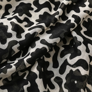 Detailed macro view of black and white abstract floral pattern on soft linen-feel fabric
