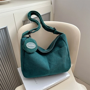 Green corduroy shoulder bag set with adjustable strap and small matching pouch