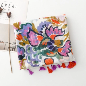 Detail of artistic watercolor floral scarf with vibrant purple and orange tassels