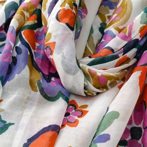 Macro detail of cotton linen scarf with watercolor floral print and woven texture