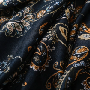 Detailed macro view of soft navy paisley fabric with delicate texture and frayed edges