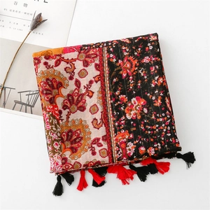 Detail of vintage bohemian scarf with ethnic floral patterns and tassel fringe edge