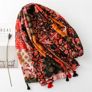 Bohemian paisley print shawl with tassels on a minimalist white background