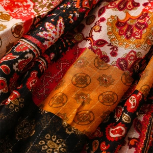 Macro detail of Bohemian Paisley fabric with metallic silver threads and patterns