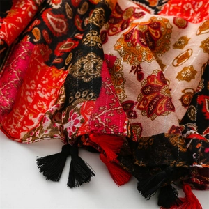 Close-up of bohemian paisley shawl with metallic silver threads and tassel details