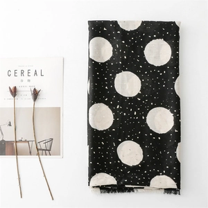 Elegant black cotton linen scarf with white polka dots and long fringe detail