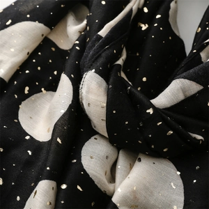 Detail of gold foil heart and polka dot patterns on black cotton-linen feel scarf
