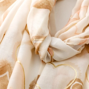Detail of soft heart pattern scarf featuring elegant gold foil outlines and fine texture