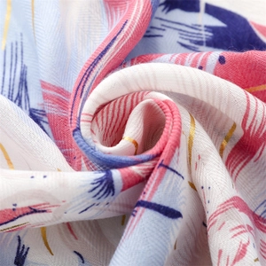 Detailed macro view of soft printed fabric with gold thread and abstract feather patterns
