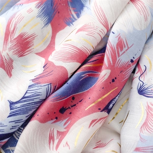 Close-up of lightweight floral scarf fabric featuring elegant gold foil stamping details