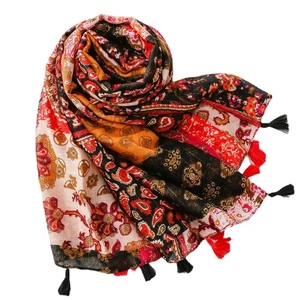 Bohemian paisley print shawl with colorful floral patterns and red tassel accents