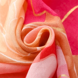 Detailed close-up of soft floral cotton scarf with gold threads and tassel finish