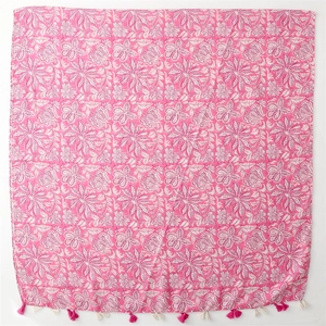 Pink and white floral cotton-linen scarf with bohemian tassels shown in flat lay