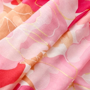 Detailed macro view of soft herringbone weave fabric with gold thread and floral print