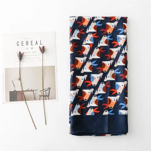 Navy blue scarf with abstract dog pattern and orange accents on white background