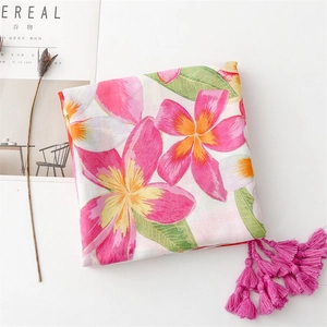Detailed view of floral cotton shawl with pink tassels and magazine aesthetic styling