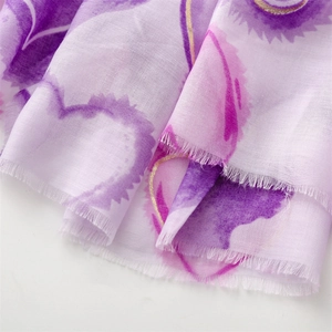 Macro detail of purple linen-feel scarf with gold foil hearts and frayed edges