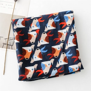 Detail of blue cotton-linen scarf featuring vibrant geometric puppy cartoon print