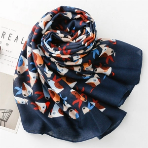 Detail of navy blue scarf with colorful cartoon dog print in elegant spiral fold