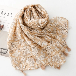 Close-up of floral linen scarf with fringe edges and natural plant pattern design