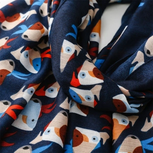 Close-up of lightweight navy blue scarf featuring abstract animal prints and soft fabric texture