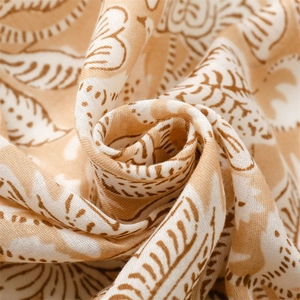 Close-up of floral print cotton linen scarf showing soft texture and artistic leaves