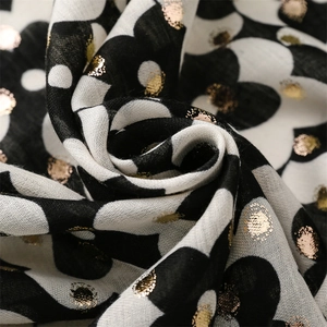 Detail of floral linen scarf with gold metallic foil dots and poppy print texture