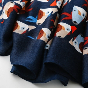 Macro shot of navy blue cotton-linen fabric with cute colorful puppy cartoon patterns
