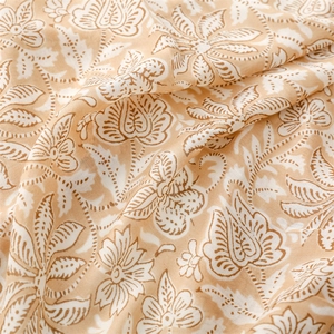 Macro detail of soft cotton linen fabric with white floral prints and natural fringe