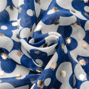 Detail of navy cotton-linen scarf featuring gold foil polka dots and floral print texture