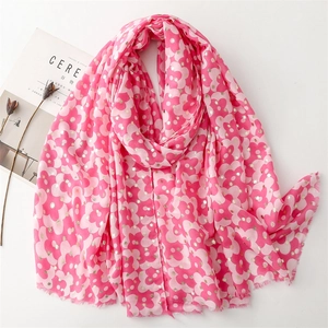Pink floral print scarf with gold foil dots and tassel fringe on white background