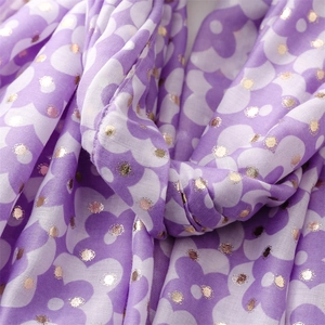 Detailed close-up of lavender floral cotton-linen scarf with gold foil polka dots