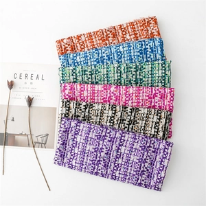 Detail of pixel pattern scarves with fringe edges in vibrant multiple color options