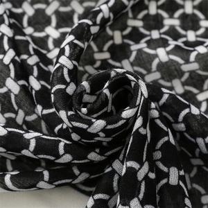 Macro detail of geometric chain pattern on cotton linen scarf with woven texture