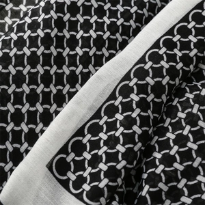 Close-up of geometric black and white interlocking chain pattern on soft linen scarf