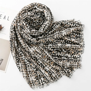 Detail of cotton-linen feel scarf with geometric plaid pattern and gold foil accents