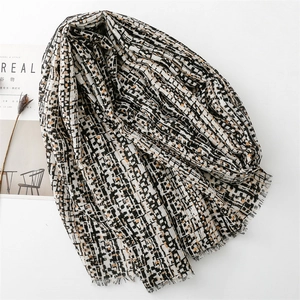 Detail of cotton linen scarf with gold foil pixel stripes and frayed tassel edges