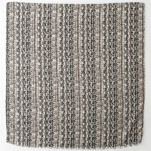 Detail of the woven texture with black and khaki patterns and short fringe edges
