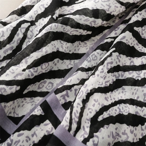 Detailed macro view of zebra and purple leopard print shawl with fine textile texture