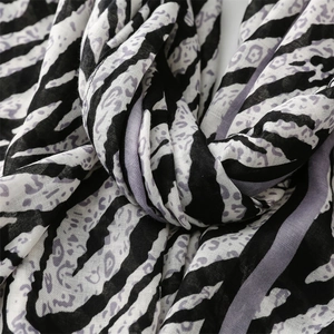 Detail showing high-quality zebra and leopard print texture on a lightweight scarf